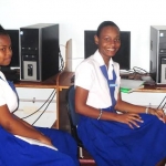 Two girls sitting at their desks